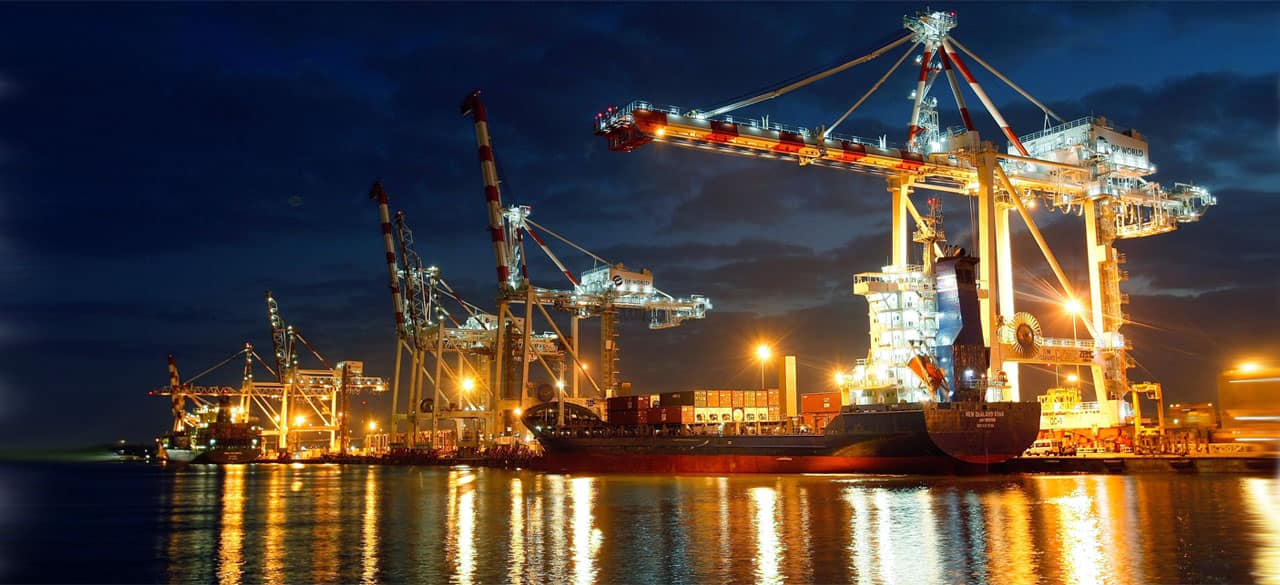 large bright container crane at the port of melbourne in the evening