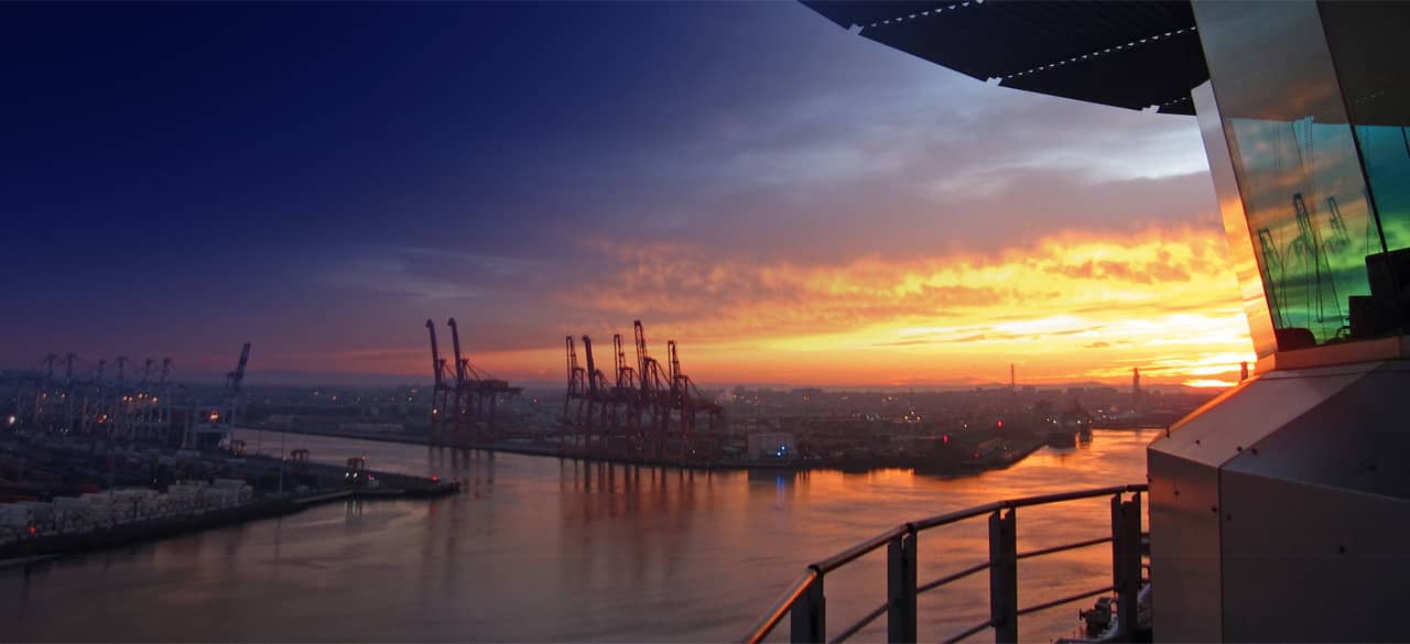 sunset view of the port of melbourne with cranes next to the victorian harbour