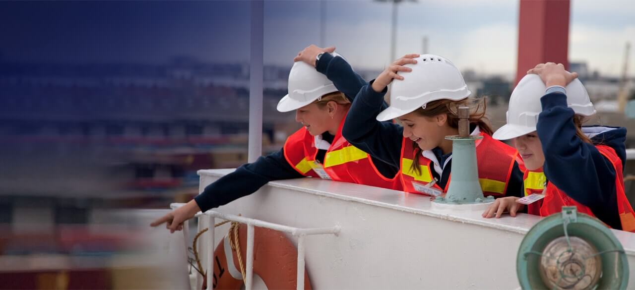 excited students in high vis vests pointing at the port of melbourne operations