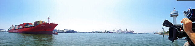 panoramic view of the port of melbourne containing a cargo vessel entering the harbour